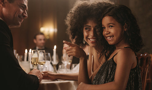 Mother and daughter at a dinner party with friends