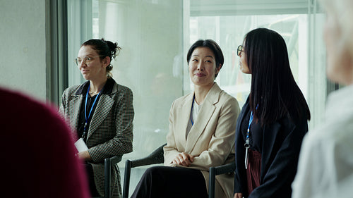 Professional women listen during business conference