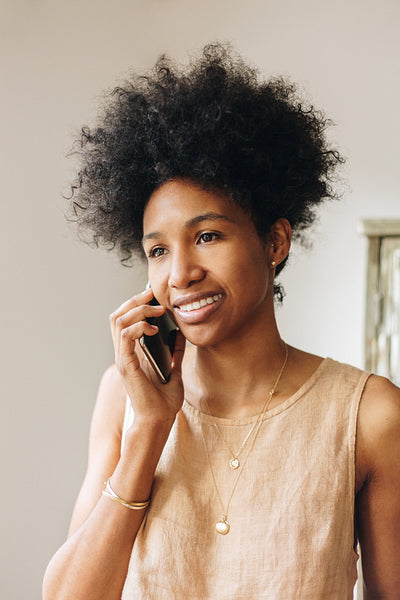 Jewelry designer talking on phone