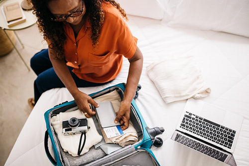 Travel planning and packing: Woman getting ready for an overseas trip