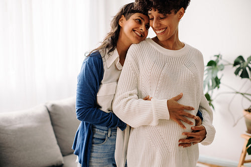 Happy lesbian couple expecting a baby