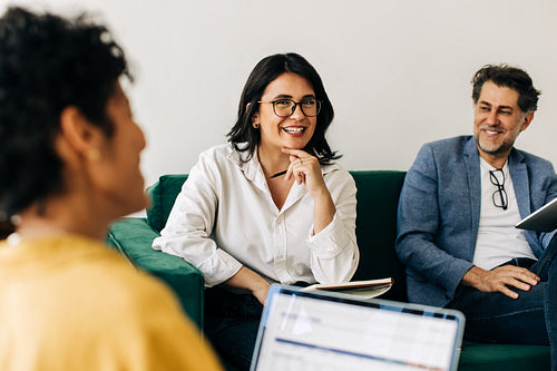 Diverse business people having a meeting with their colleague in an office