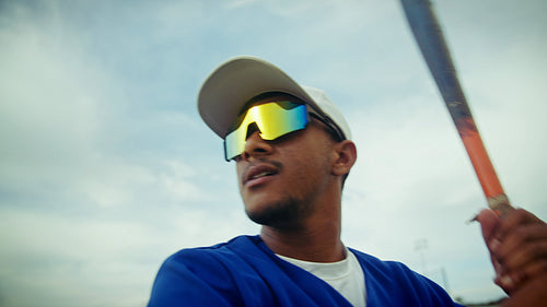 Baseball hitter prepares to swing, showing intense focus.