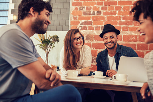 Group of young friends hanging out at a cafe