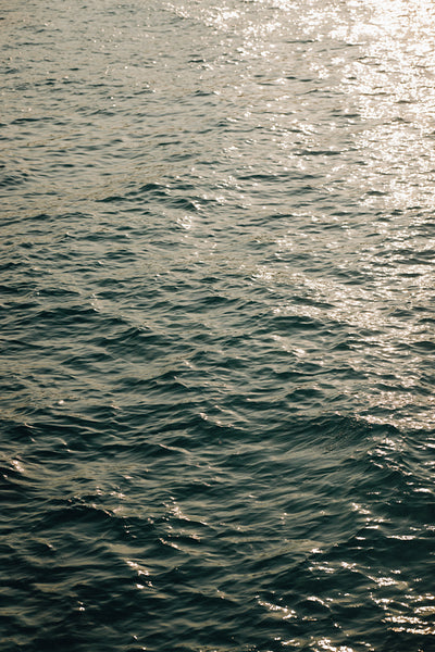 Calm and peaceful ocean water with sunlight reflections