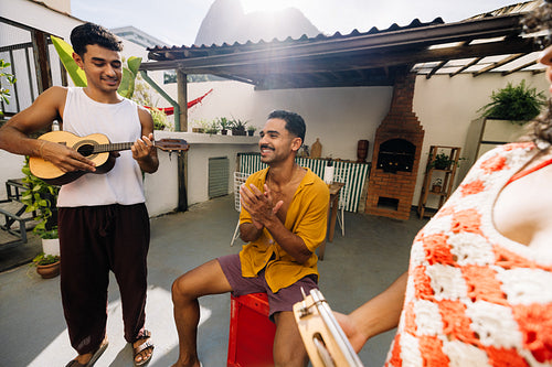 Group of friends enjoying live music in a Rio de Janeiro backyard