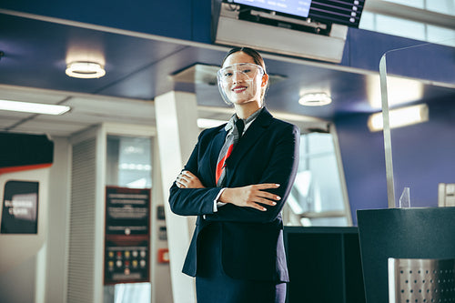 Friendly ground attendant with face shield at airport
