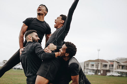 Happy football players celebrating victory