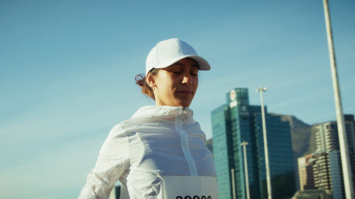 Runner pauses before an urban marathon