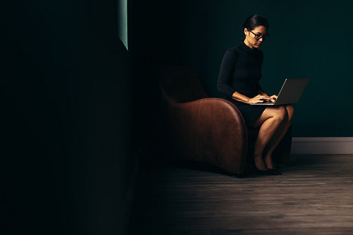 Asian businesswoman working on laptop in office