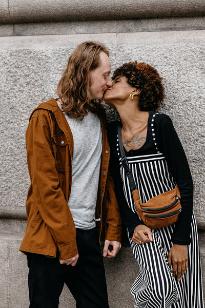 Intimate moment shared by affectionate couple on city street