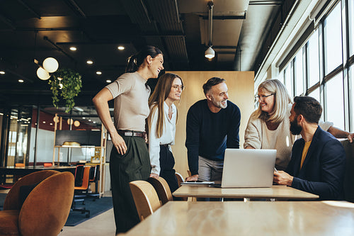 Smiling businesspeople having a discussion in an office