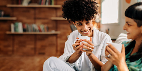 Lovely lesbian couple having coffee together