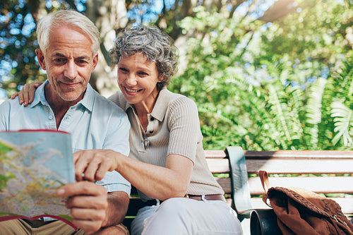 Happy senior tourist  reading map 