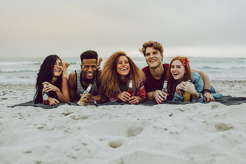 Friends having beers at the sea shore