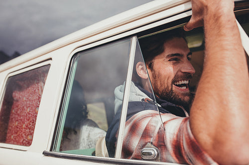 Man driving van and enjoying on his road trip