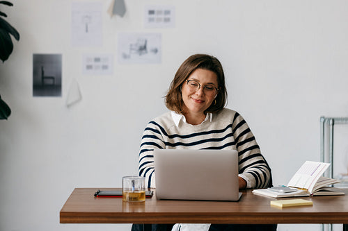 The woman builds a calm workspace at her home office desk