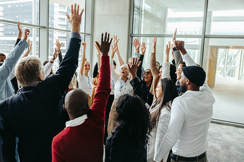 Successful team energizing at conference during a productive training day in a modern office environment with diverse coworkers