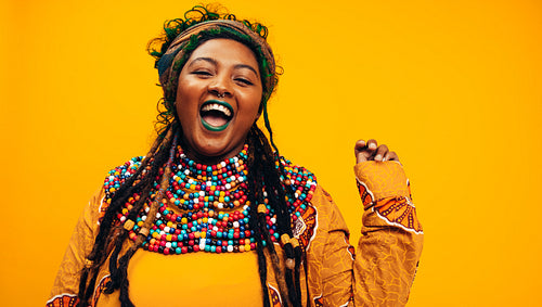 Excited ethnic woman wearing cultural clothing