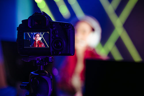 Gaming content creator live recording herself with a camera