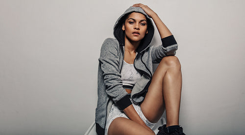 Sporty woman in grey hoodie sportswear