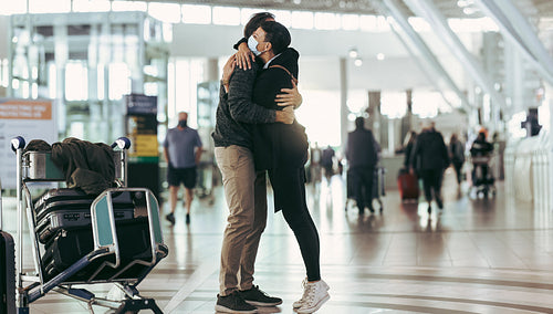 Couple reuniting at airport