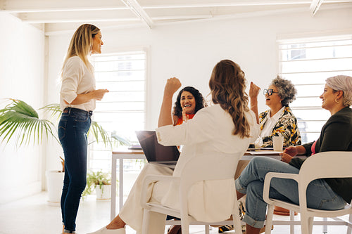 Happy businesswomen celebrating during a meeting