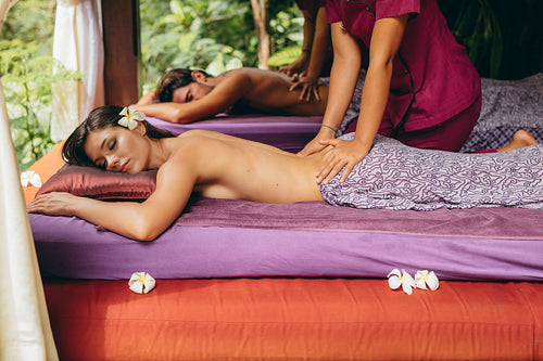 Couple at spa center having back massage