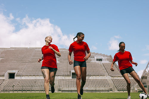 Female football players training on soccer field