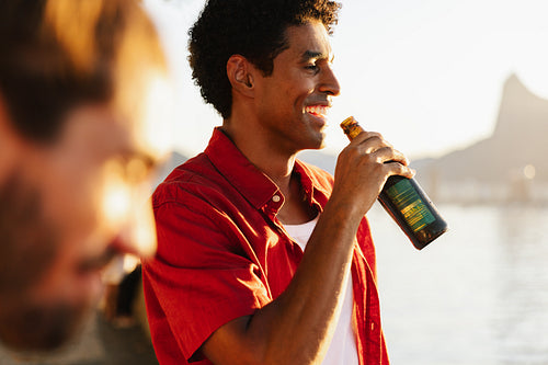 Man enjoying a cold beer during sunset at Corcovado Hill