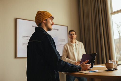 Business team presenting with laptop in office meeting