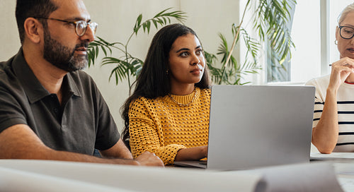 Architectural team brainstorming during a meeting at a modern firm office setting