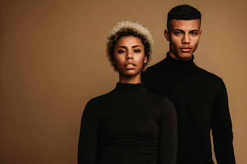 African american couple standing together on brown background