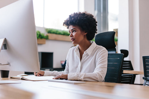 African woman working at her office desk