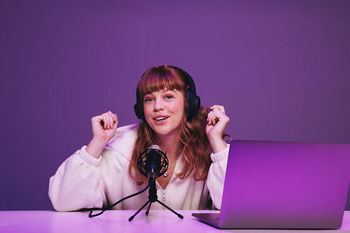 Woman recording a live podcast in a studio