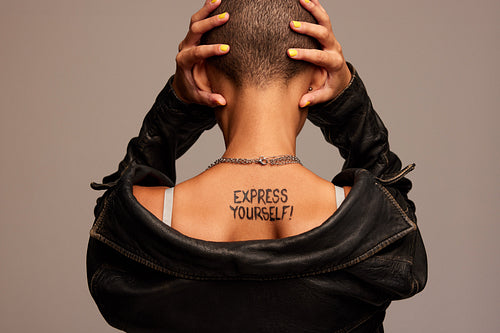 Androgynous woman covering her ears