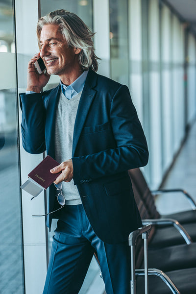 Businessman talking on phone at airport lounge
