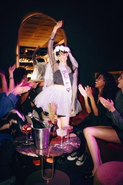 Bride celebrating with friends at a bachelorette party in a joyful atmosphere