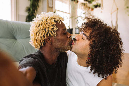 Young gay couple taking a selfie together