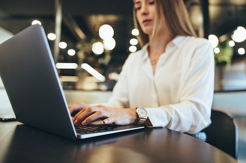 Businesswoman typing on a laptop at work