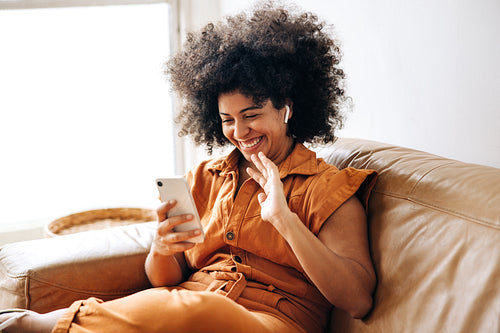 Smiling businesswoman having a video call in an office lobby