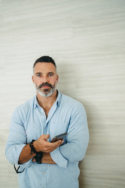 Mature businessman standing against a wall in an office