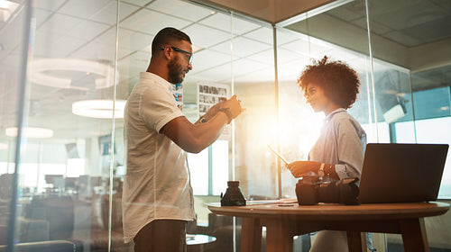 Photographers discussing creative ideas in office
