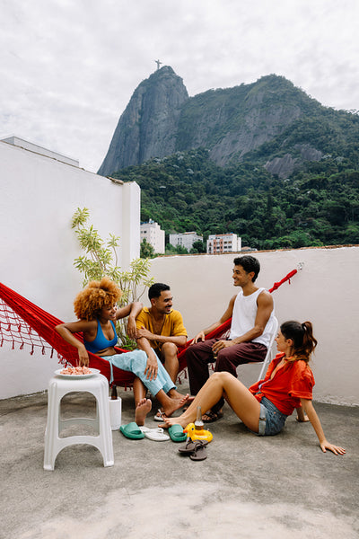 Friends enjoying a rooftop gathering with Corcovado view in Rio de Janeiro