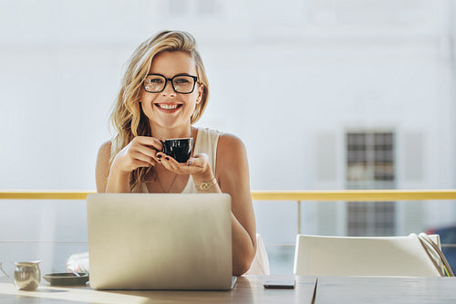 Businesswoman having coffee at coffeeshop