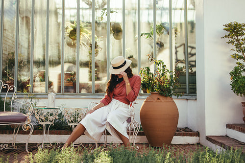 Tourist woman tipping her summer hat outdoors
