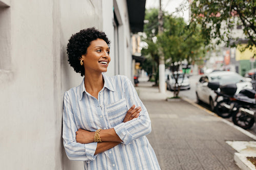 Happy young woman smiling cheerfully in the city