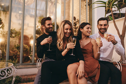 Happy couples raising their glasses to make a toast on a double