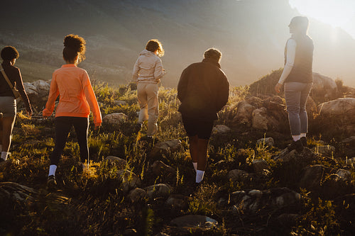 Friends hiking together at sunset