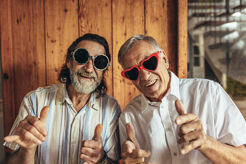 Senior men wearing funny sunglasses